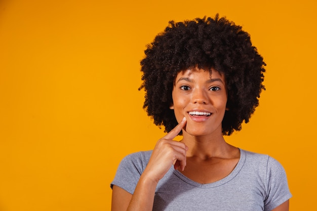 Femme afro pensant sur le jaune avec un espace réservé au texte