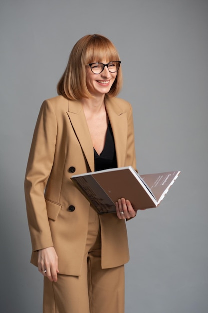 Femme d'âge moyen avec des lunettes et un livre