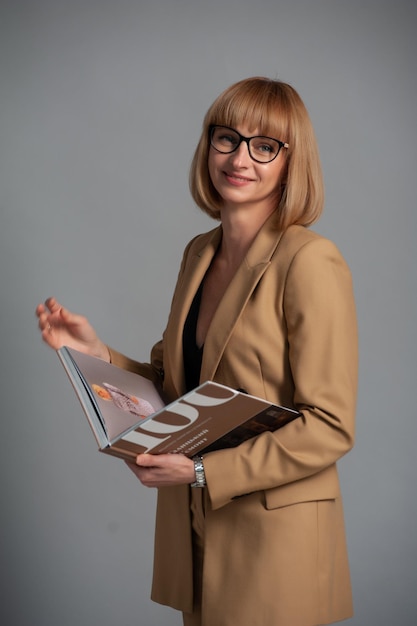 Femme d'âge moyen avec des lunettes et un livre