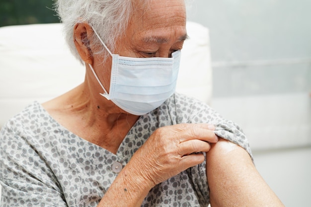 Une femme âgée asiatique se fait vacciner pour protéger le virus corona
