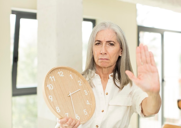 Photo femme âgée avec une horloge