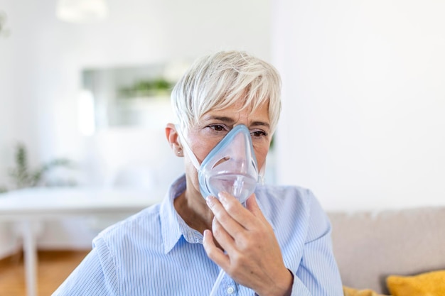 Une femme âgée malade fabriquant un médicament d'inhalation est le meilleur médicament Une femme âgée malade portant un masque à oxygène et subissant un traitement pour COVID-19 Une femme âgé avec un inhalateur