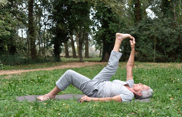 femme âgée pratiquant le yoga en plein air