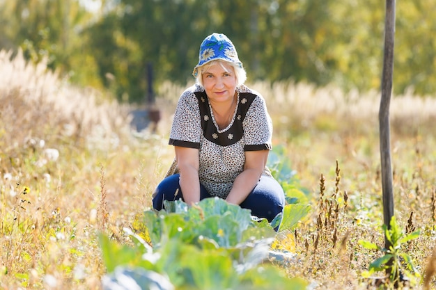 Femme d'agriculteur sur un lit de chou