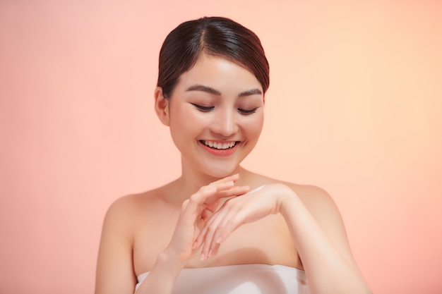 Femme appliquant une crème hydratante sur les mains