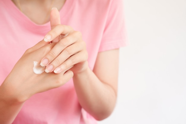 Femme appliquant une crème de soin de peau