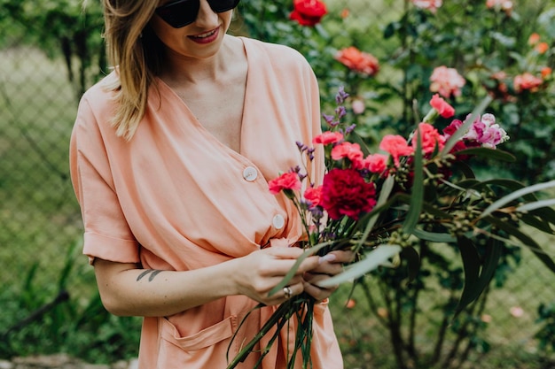 Femme arrangeant des fleurs dans un jardin