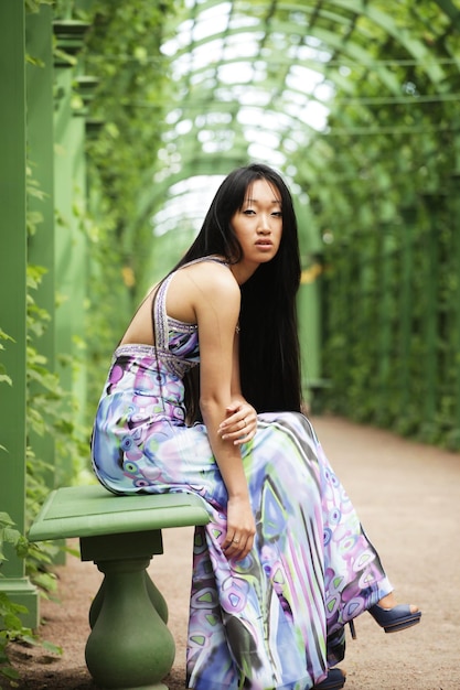 Femme asiatique assise sur le banc du parc