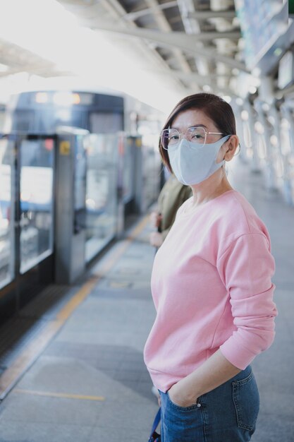 Femme asiatique se préparant à porter un masque de protection permanent en plein air