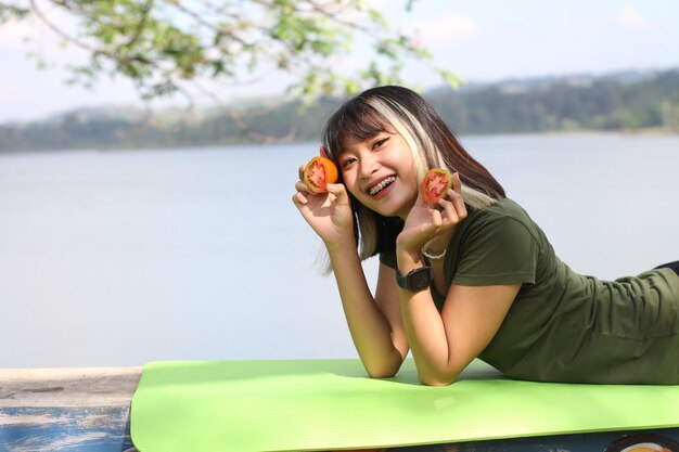 Femme asiatique tenant des tomates le matin