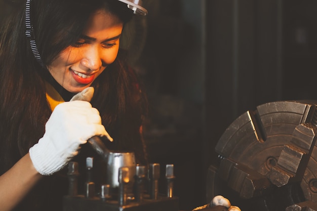 Femme asiatique travaillant dans l&#39;usine, l&#39;industrie à l&#39;aide de machine à heureux.