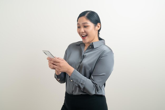 Femme asiatique utilisant un smartphone ou un téléphone portable sur fond blanc