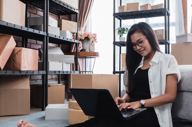 Femme asiatique vérifier les colis d'expédition