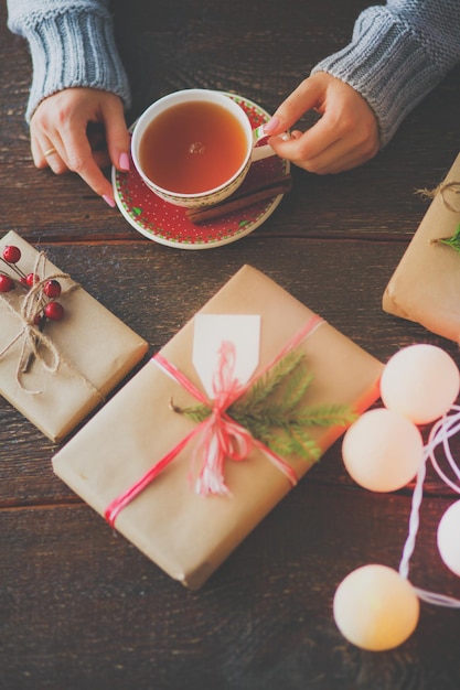 Femme assise sur le bureau avec boîte-cadeau de Noël