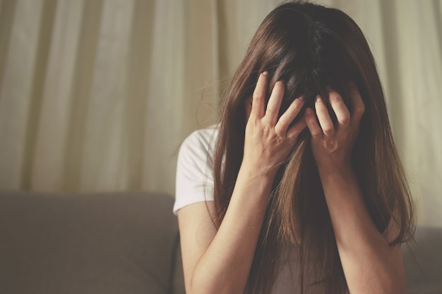 Une femme assise stressée, déprimée, insomniaque qui a rompu avec son copain.