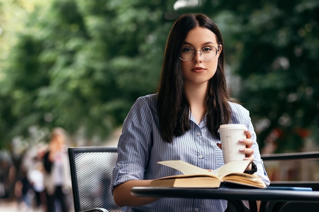 Femme assise sur la terrasse et livre de lecture