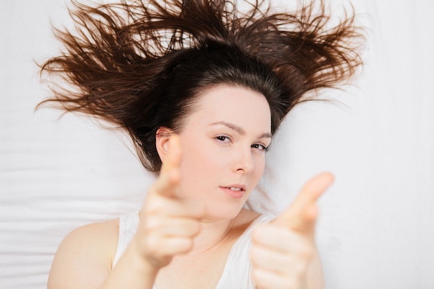 femme au lit sur une feuille blanche avec différentes émotions