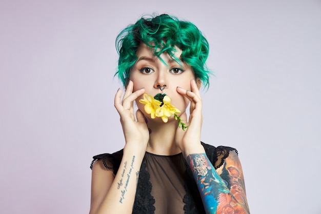 Femme aux cheveux créatifs et coloration verte créative, mèches de cheveux toxiques.