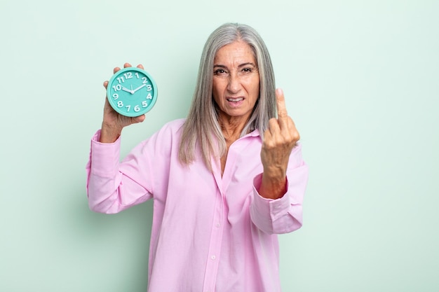 Femme aux cheveux gris d'âge moyen se sentant en colère, agacée, rebelle et agressive. concept de réveil