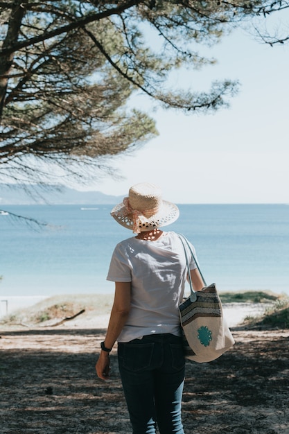 femme aux cheveux gris à la plage pendant une journée super ensoleillée concept de liberté senior copy space sun