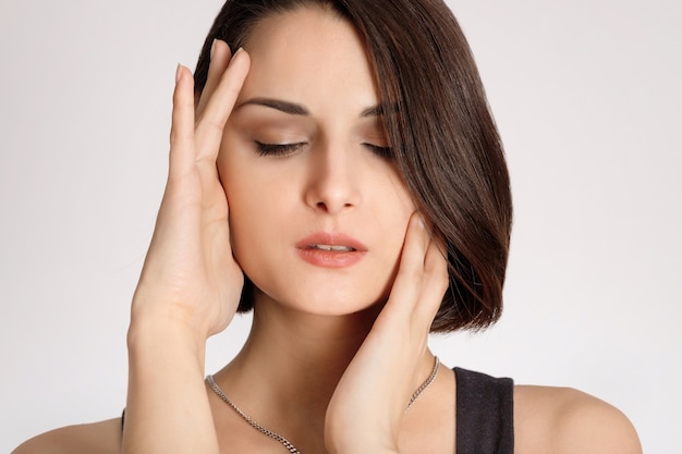 Femme de beauté métisse avec une peau parfaitement saine portrait Beau modèle brune touchant le visage