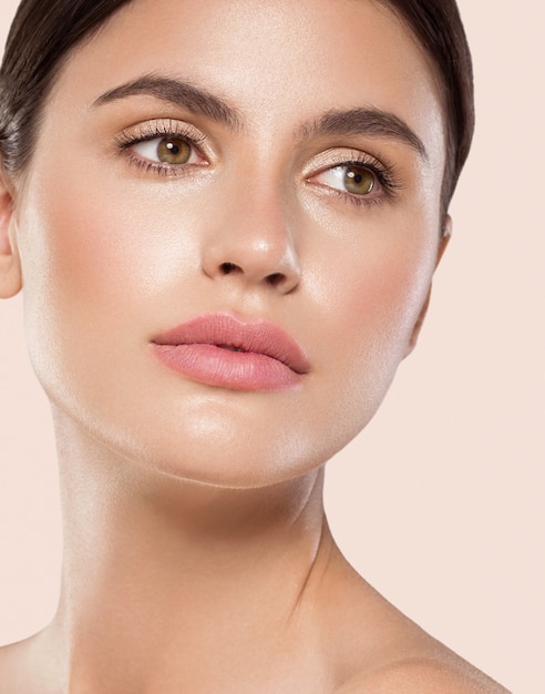 Femme beauté visage sain peau propre maquillage naturel beauté yeux femme jeune modèle Fond beige.