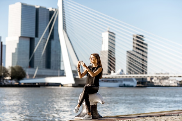 Femme bénéficiant d'une belle vue sur le paysage urbain au bord de la rivière moderne pendant la matinée dans la ville de Rotterdam