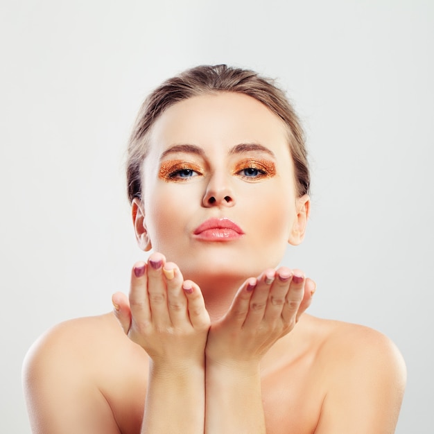 Femme en bonne santé avec une peau claire Blowing Kiss à la caméra. Concept de spa et de soins de la peau