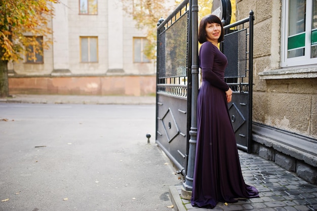 Femme brune adulte à fond de robe violette portes de fer noir