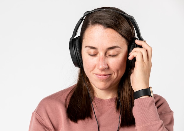 Femme brune écoutant de la musique