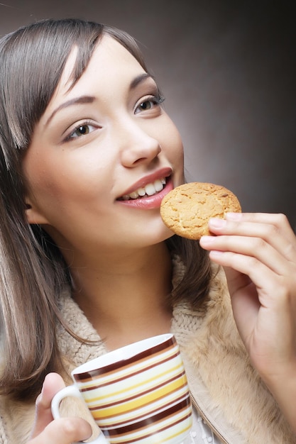 Femme avec café et biscuits