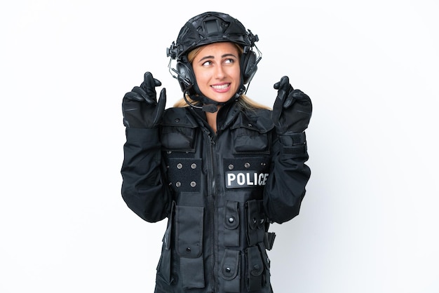 Femme caucasienne SWAT isolée sur fond blanc avec les doigts croisés