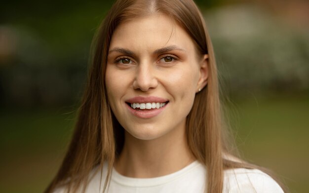 Une femme avec une chemise blanche qui dit "sourire" dessus