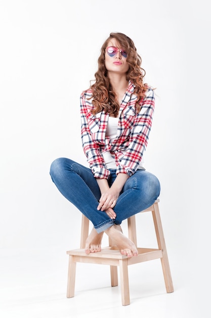 Femme en chemise à carreaux jeans et lunettes de soleil