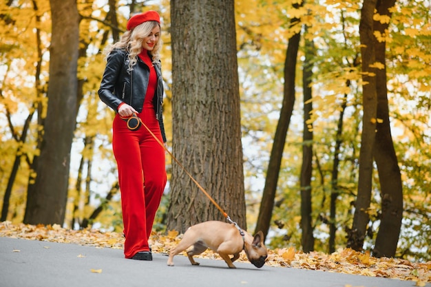 Femme avec chien marchant dans le parc