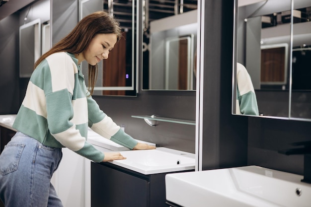 Femme choisissant un lavabo en magasin