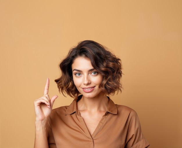 Une femme confiante pointant vers le haut avec un sourire.