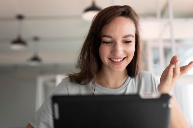 Femme de coup moyen avec tablette