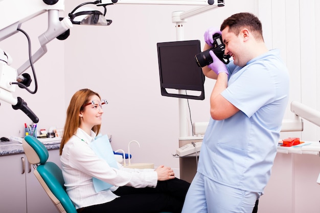 Femme dans un cabinet de dentiste choisissant la couleur et le type de prothèse dentaire