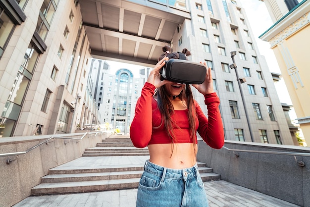 Femme dans un casque de réalité virtuelle marche dans la rue