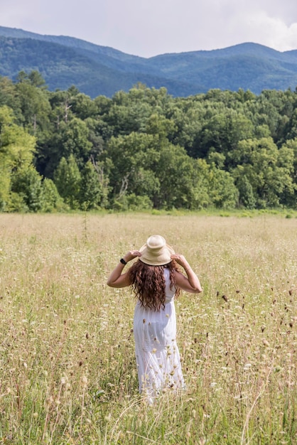 Une femme dans un champ avec un chapeau