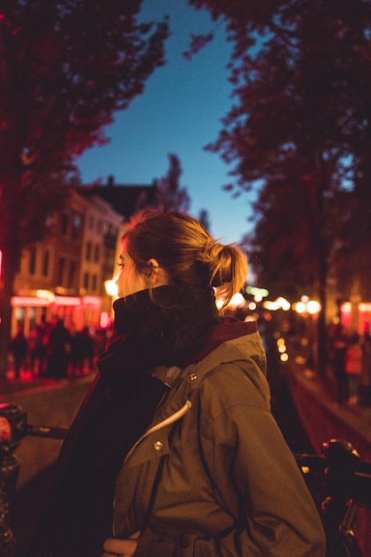 Photo une femme dans la rue la nuit