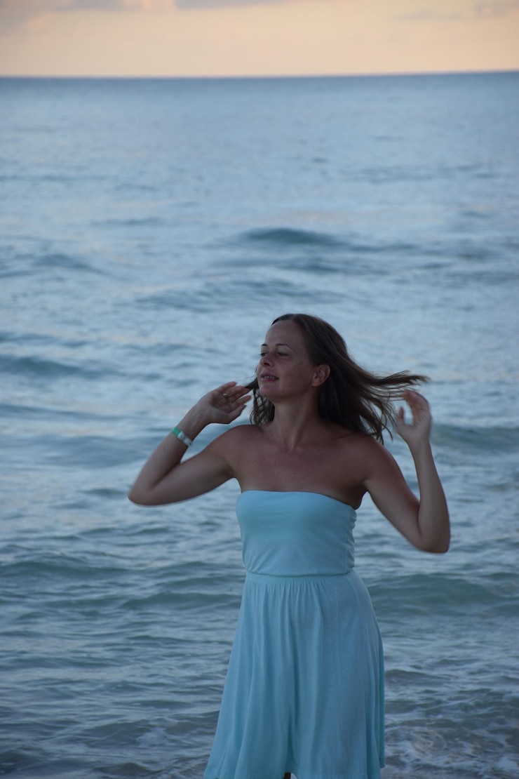 Photo une femme debout contre la mer sur la plage