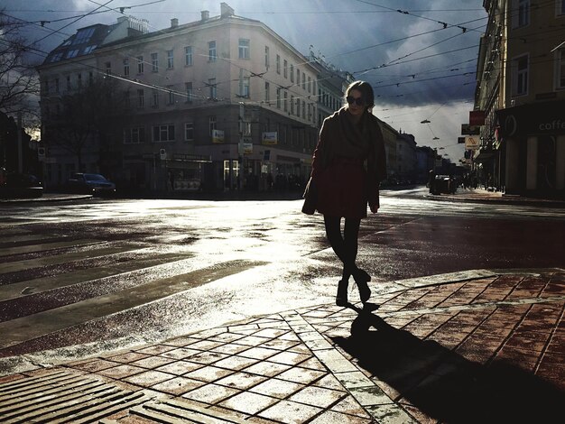 Une femme debout dans une rue de la ville