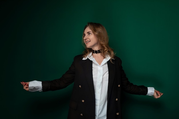 Une femme devant un mur vert.