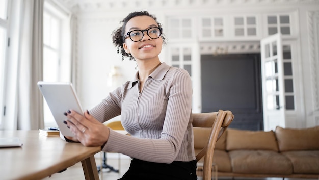 Une femme du millénaire travaille au bureau sur un nouveau projet dans une société financière utilise un ordinateur portable sur la table