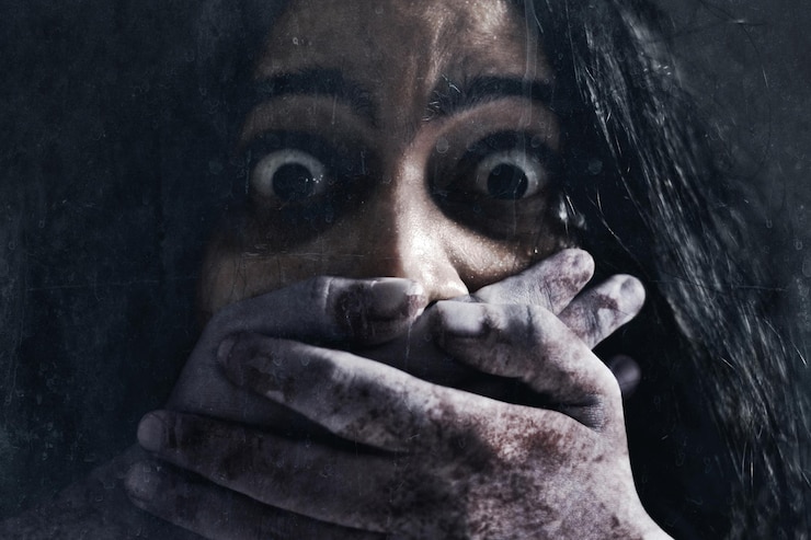 Photo une femme effrayée sur un fond sombre.