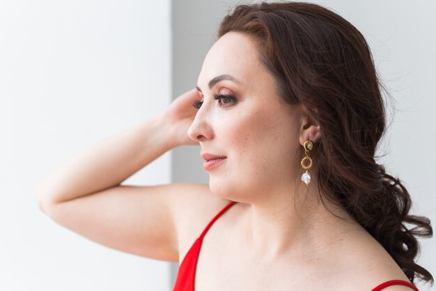 Femme élégante avec boucles d'oreilles, gros plan portrait. Concept d'accessoires, de bijoux et de bijouterie.