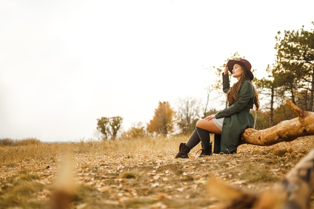 Femme élégante profitant du temps d'automne dans le pré