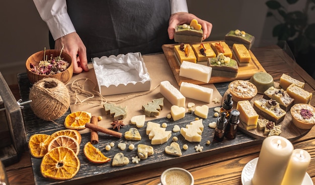 La femme emballe un beau savon naturel dans une boîte et la décore